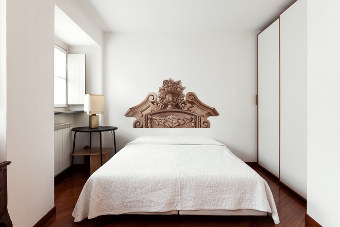 Bedroom with bed and ornate headboard decal