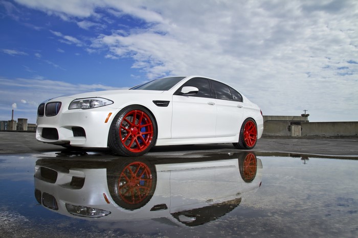 White BMW M5 F10 with red wheels