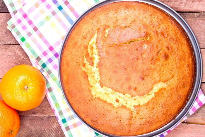 Orange cake in a pan with oranges