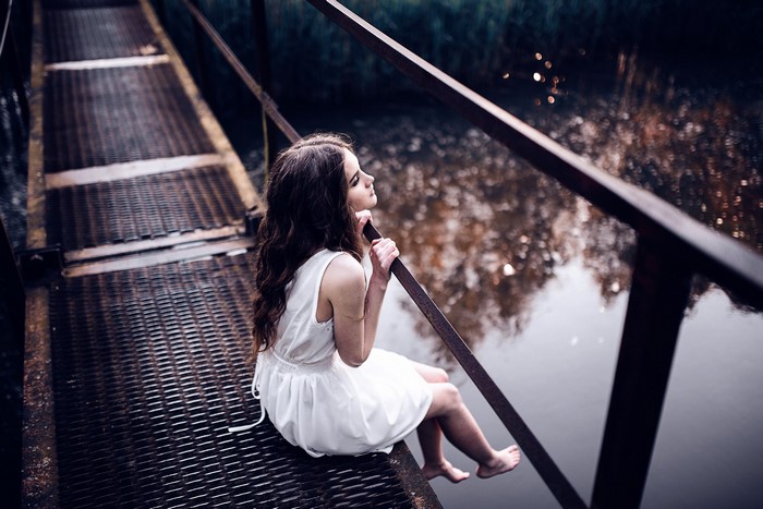 Victoria Berngard sitting on a bridge