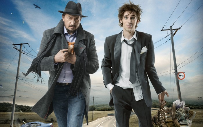 Two men walking on a road with power lines