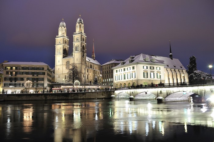 Grossmünster church and Limmat river at night in Zurich, Switzerland