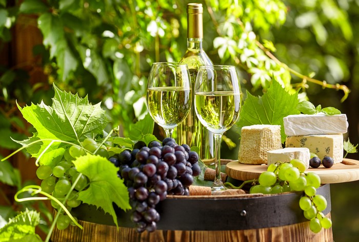 Wine, Grapes, and Cheese on a Barrel