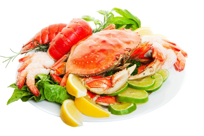 Seafood platter with crab, lobster, shrimp, lemon, and lime