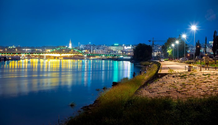 Belgrade cityscape with bridge and river at night