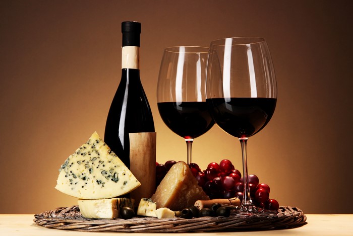 Wine bottle, glasses, cheese, and grapes