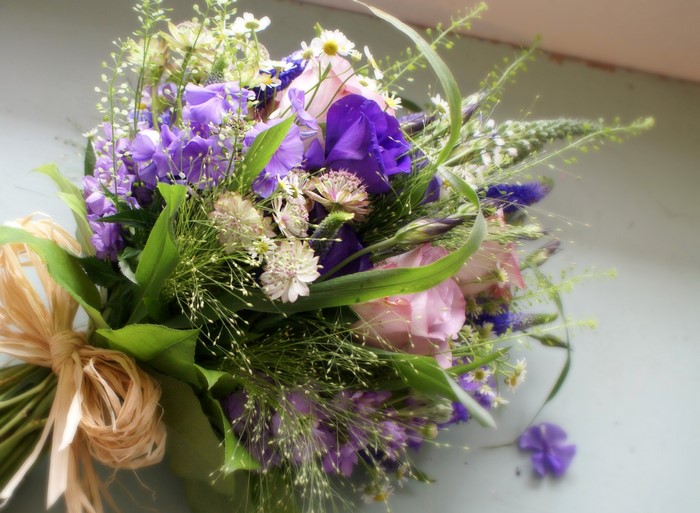 Purple and pink floral bouquet with straw bow