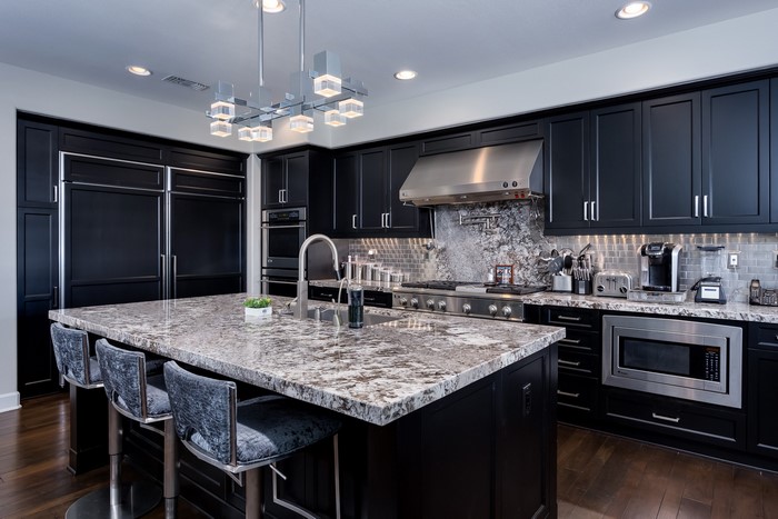 Modern black kitchen with island and bar stools