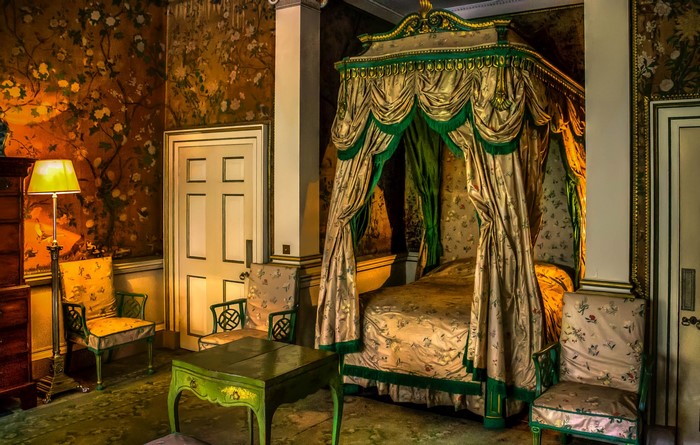 Ornate Bedroom with Canopy Bed and Floral Wallpaper