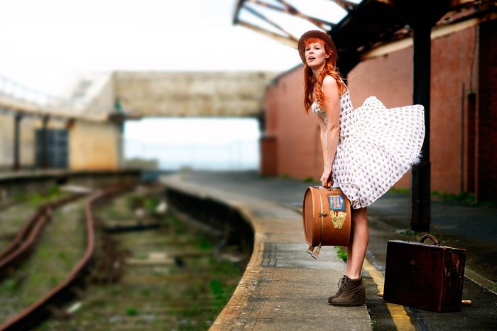 Woman with suitcases at a train station