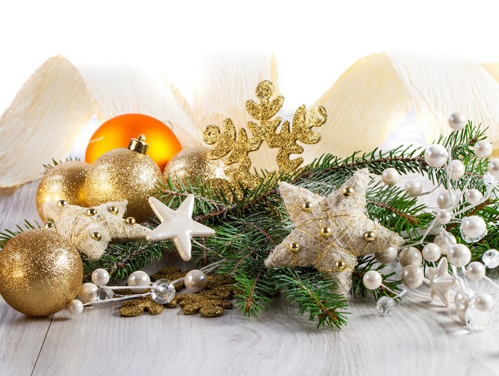 Christmas ornaments and pine branches on a wooden surface
