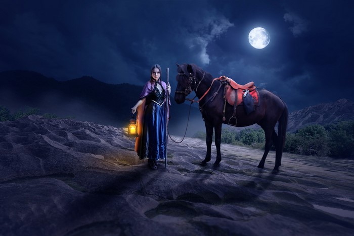 Woman with lantern and horse under the moon