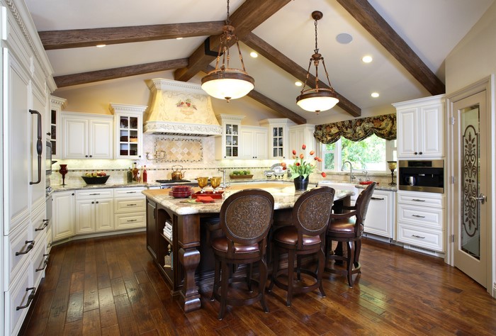Luxury kitchen with island, chandeliers, and vaulted ceiling