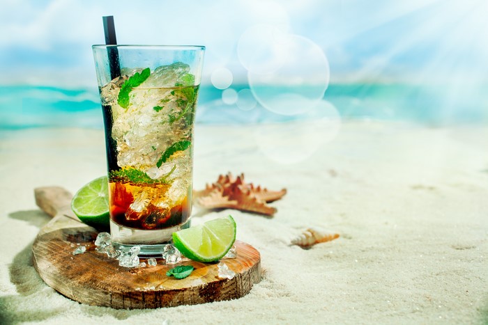 Cocktail with lime and mint on the beach