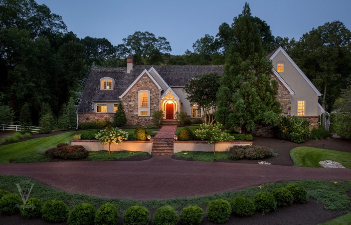 Stone and Stucco House with Landscaping at Dusk