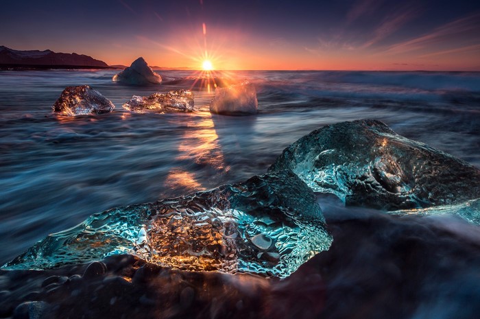 Icebergs on a beach at sunset in Iceland