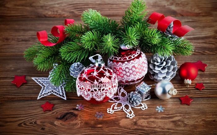 Christmas ornaments and pine branches on wooden background