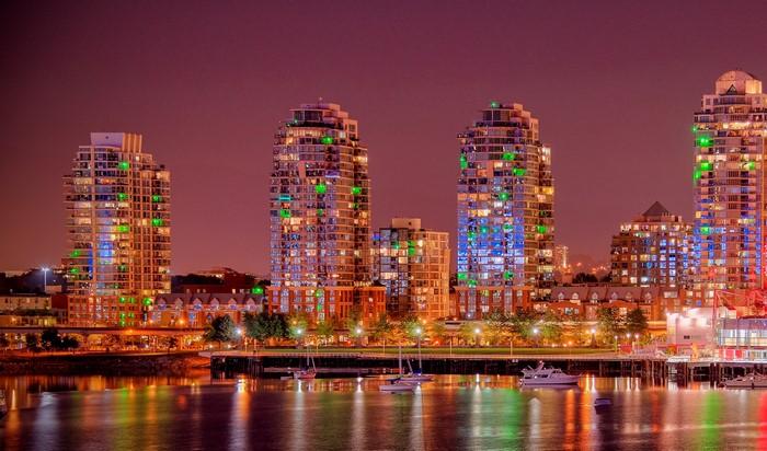 Vancouver skyline with illuminated buildings and harbor at night