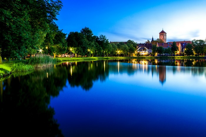Szczytno, Poland at night with lake and buildings