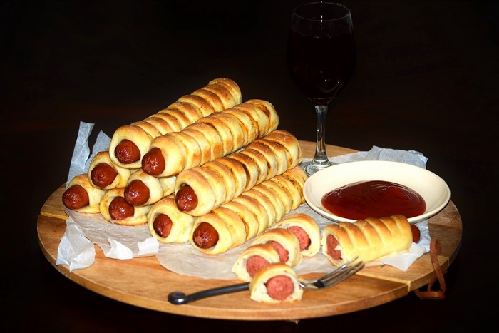 Pigs in a blanket with ketchup and wine