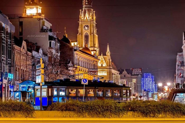 Novi Sad at night with a tram and church