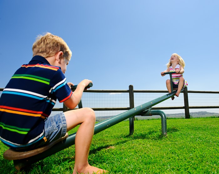 Boy and girl on a seesaw