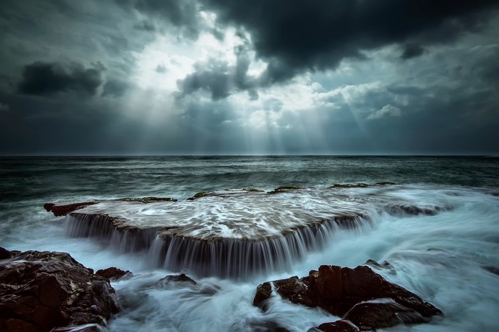 Coastline with dramatic clouds and sun rays
