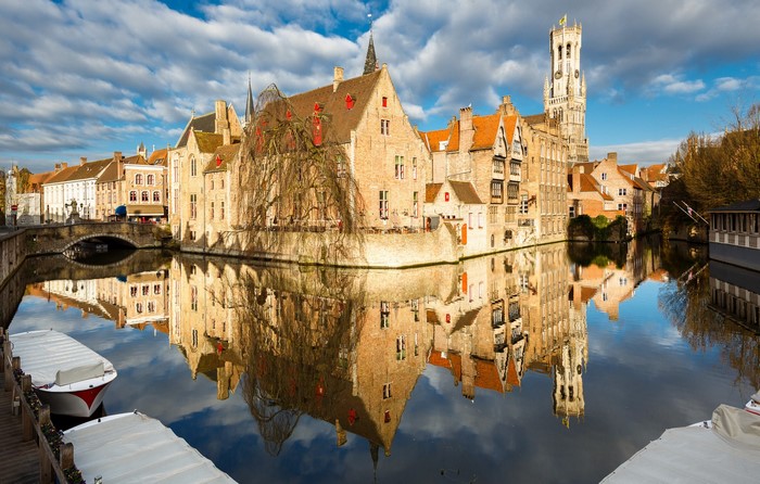 Bruges canal with historic buildings and Belfry tower
