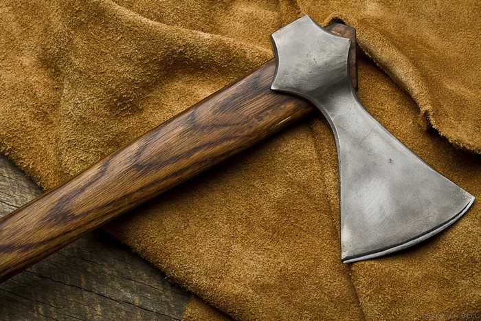 Close-up of a battle axe on brown suede