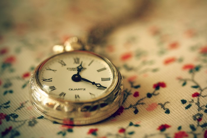 Pocket watch on floral fabric