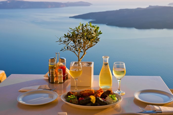 Table setting with food and wine overlooking the sea