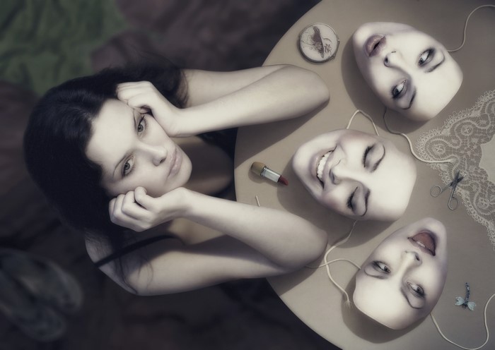 Woman with multiple masks on a table
