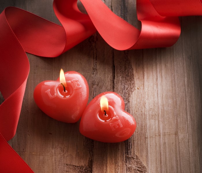 Heart-shaped candles with "LOVE" and red ribbon