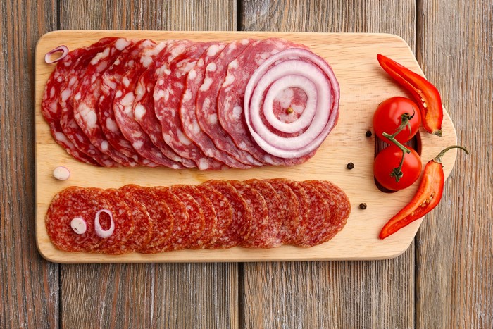 Sausage, Onion, Tomatoes, and Chili Peppers on a Cutting Board