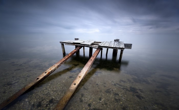 Old wooden pier on a calm lake