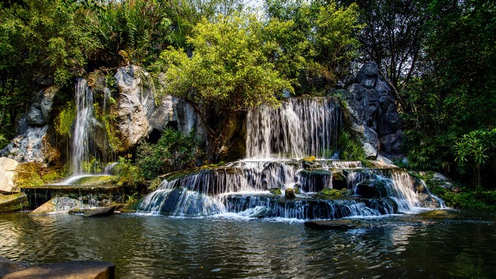 Multi-tiered waterfall cascading over rocks into a pool