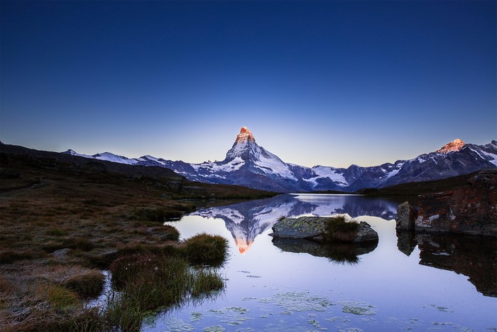 Matterhorn mountain reflected in a lake at sunrise
