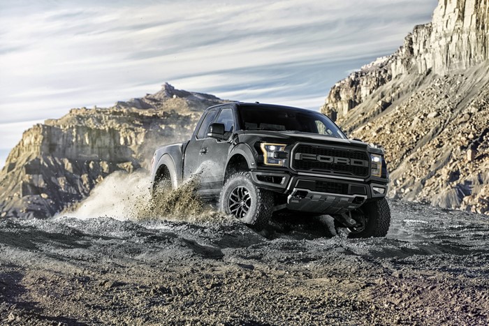 4K Black Ford F-150 Raptor driving off-road