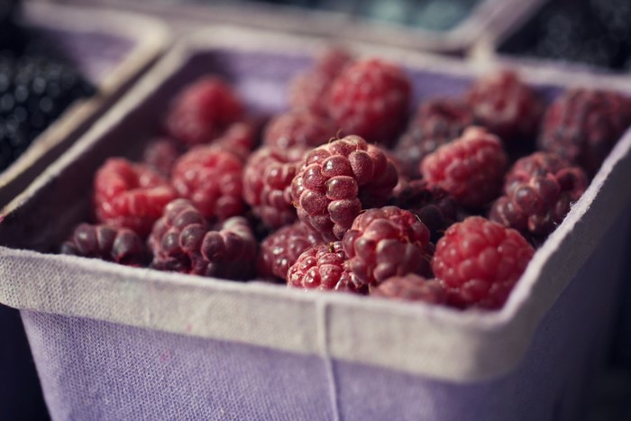 Raspberries in a purple carton