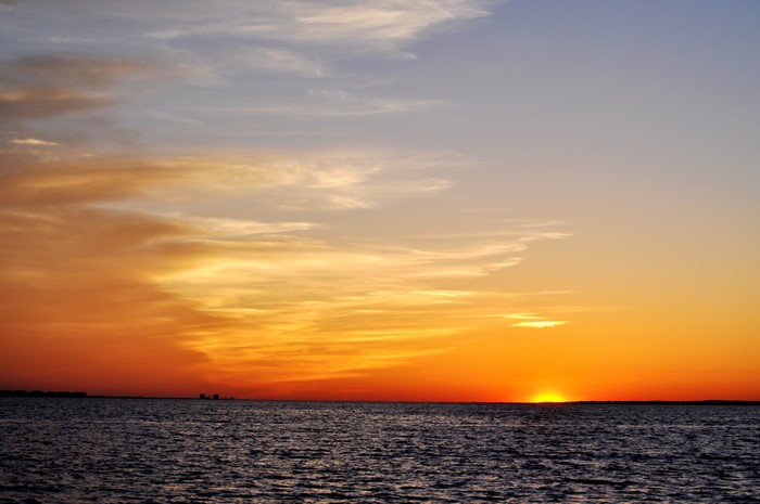 Sunset over the ocean with clouds