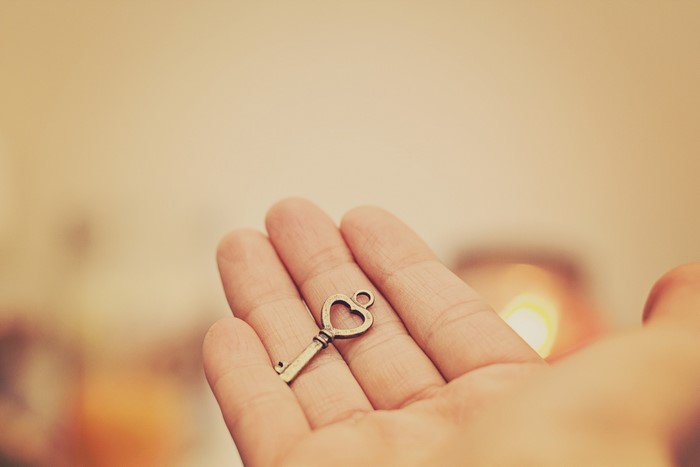 Hand holding a heart-shaped key