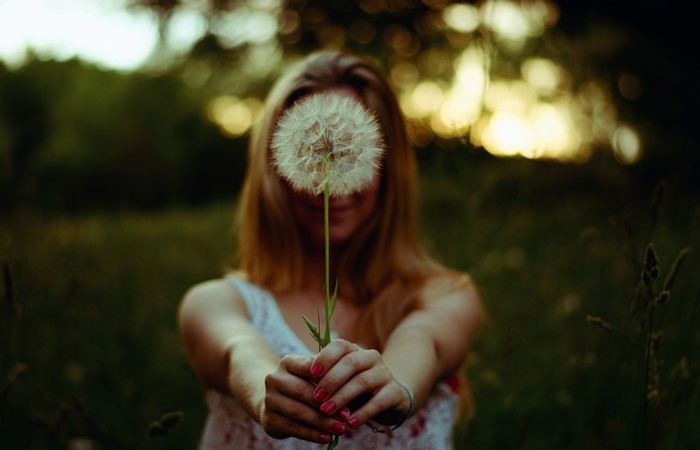Woman holding a dandelion