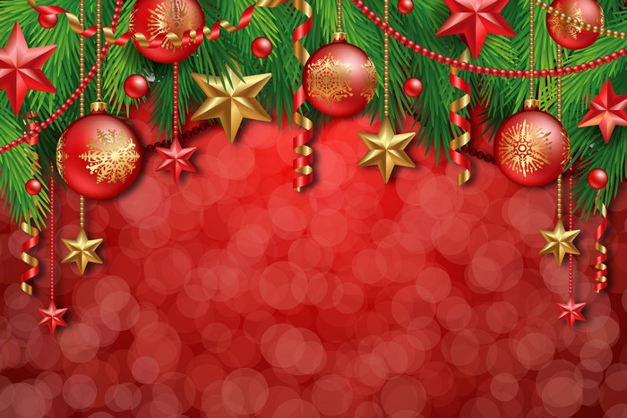 Christmas ornaments and fir branches on red bokeh