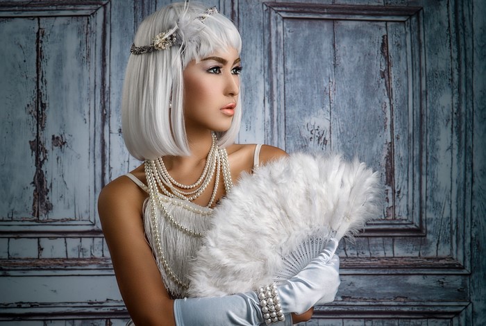 Asian woman in 1920s attire with feather fan
