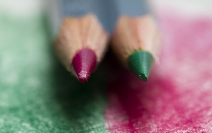 Two colored pencils, magenta and green