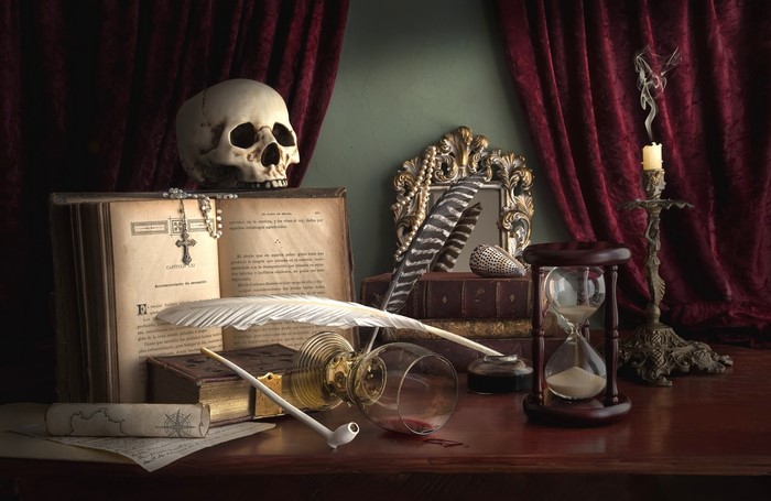 Gothic still life with skull, hourglass, and books