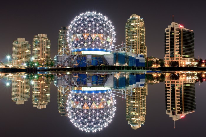 Vancouver skyline with Science World at night reflected in water