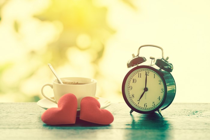 Alarm clock and coffee cup with hearts