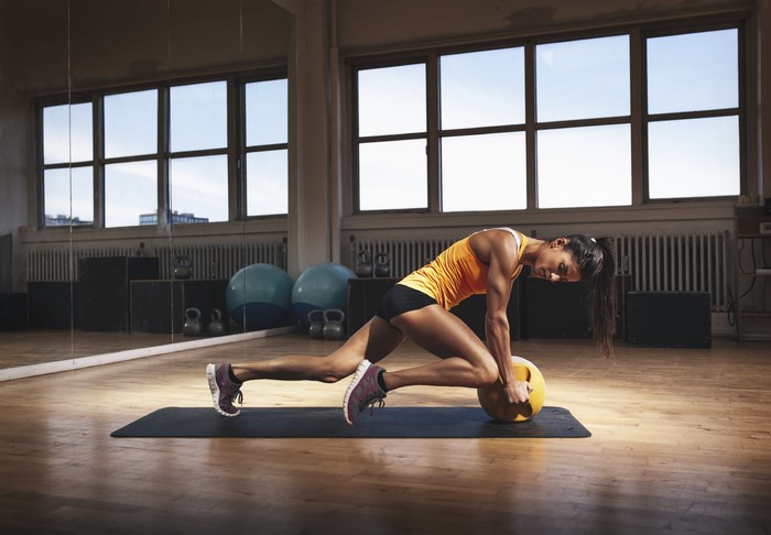 Woman exercising with medicine ball in gym