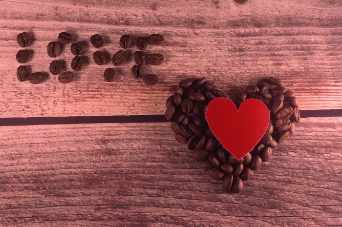 Coffee beans spelling LOVE next to a heart shape